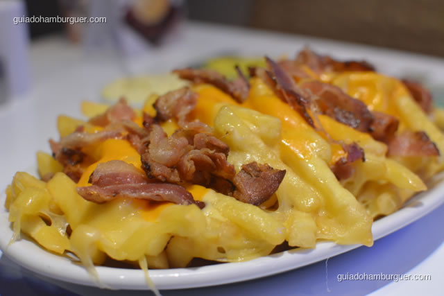 Detalhe da batata coberta de queijo, cheddar e bacon crocante - Hamburgueria da Mooca